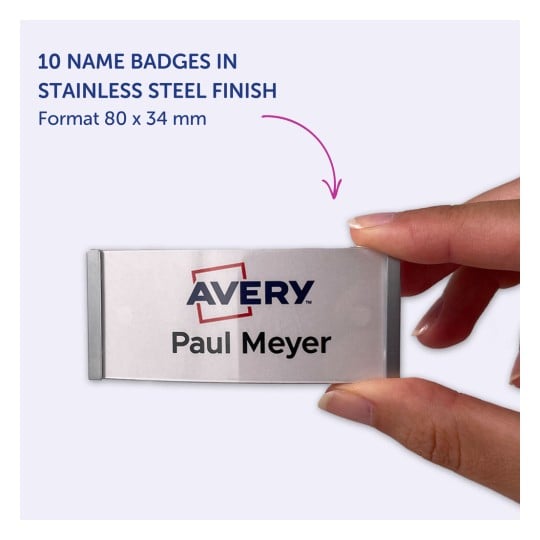 Bildet viser 10 navneskilt i en finish av rustfritt stål, med logoen 'Avery' og navnet 'Paul Meyer'. Skiltene blir vist i en persons hånd.