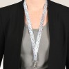 Bildet viser en person som har på seg en svart blazer over en grå skjorte, med et fargerikt blomstrete nøkkelbånd rundt halsen som holder et ID-kort.
